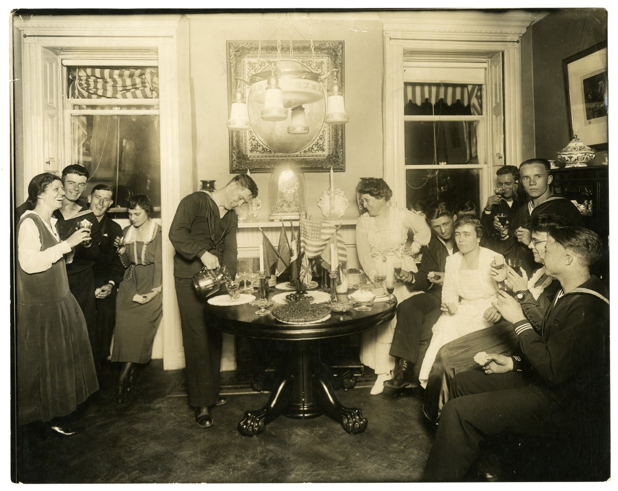 Alice Foote MacDougal entertaining a group of sailors in her small apt in Old War, Greenwich Village, New York, USA, c.1917-18 by Jessie Tarbox Beals