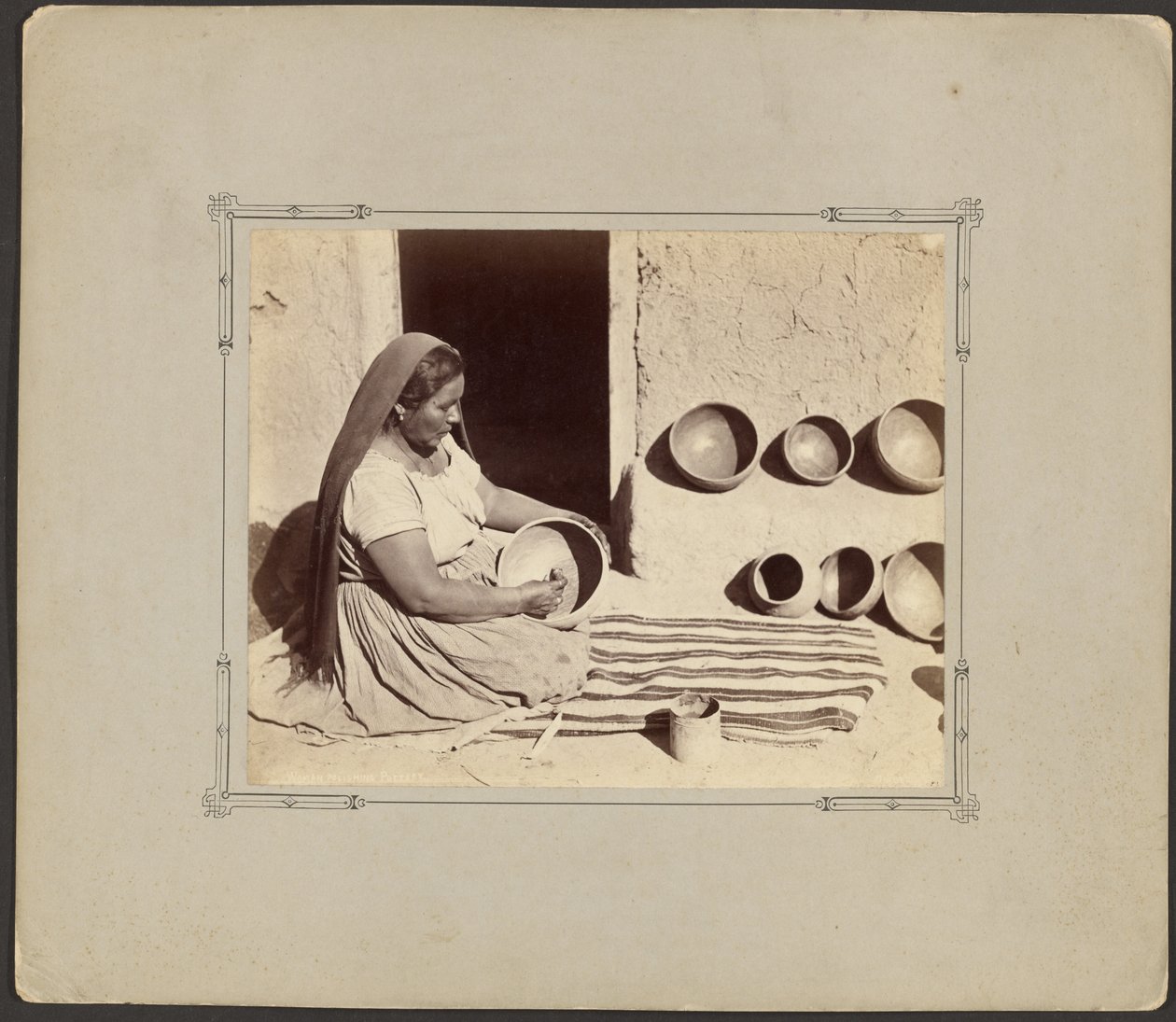 Woman Polishing Pottery by John K. Hillers