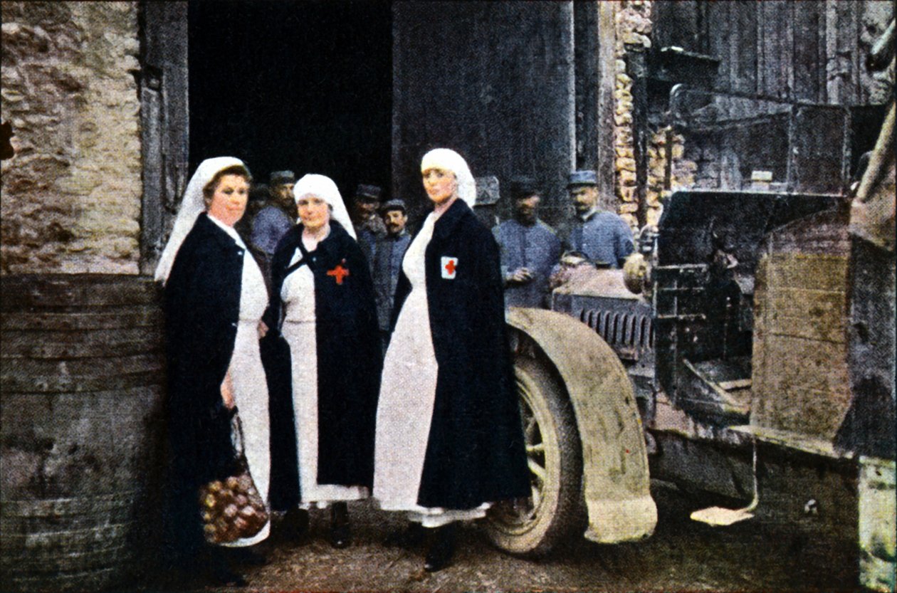 Three Women Wearing the Red Cross and the French Ambulance Staff with a Vehicle, Verdun, September 1916 by Jules Gervais Courtellemont