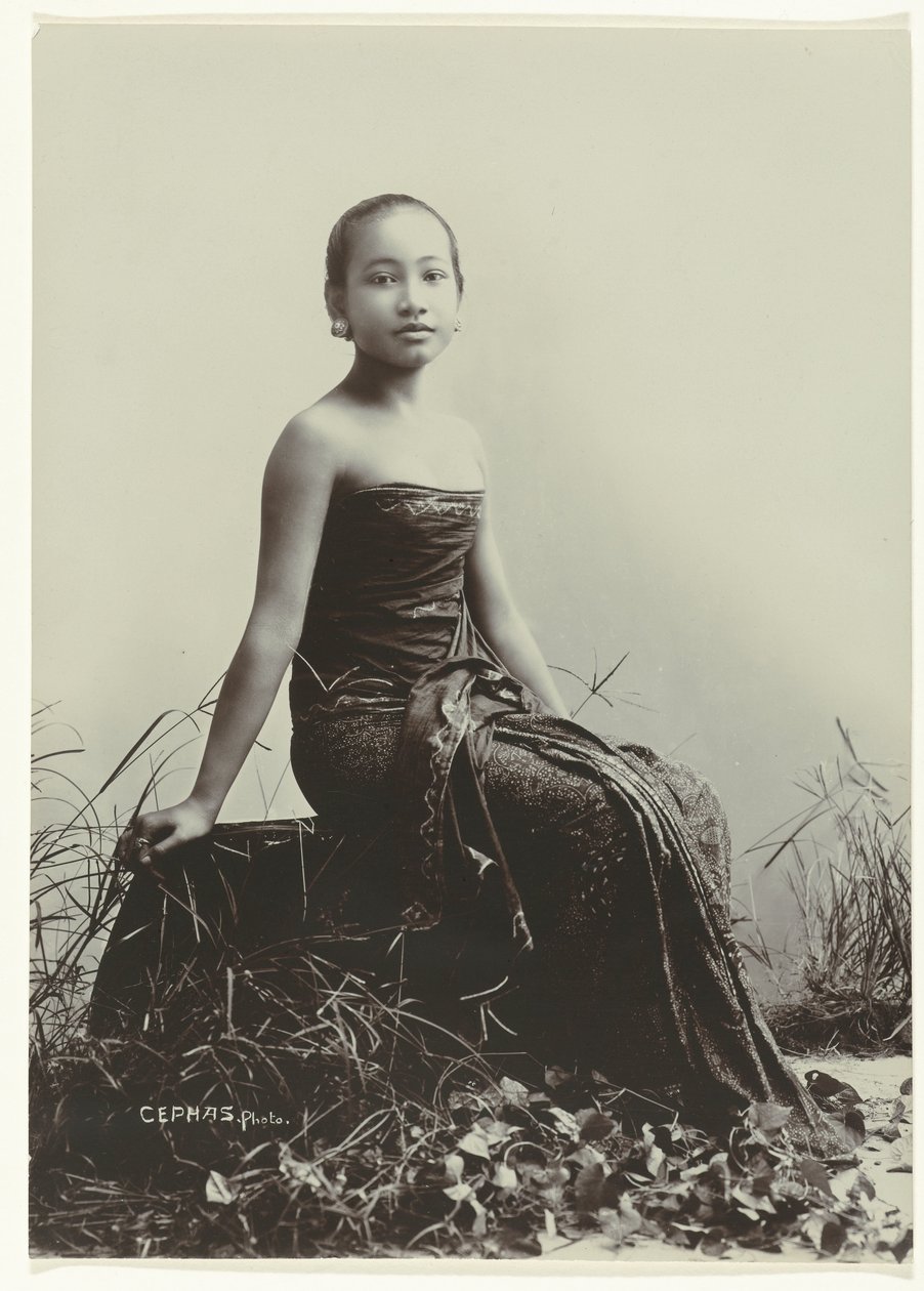 Studio Portrait of a Javanese Woman Sitting on a Log by Kassian Cephas