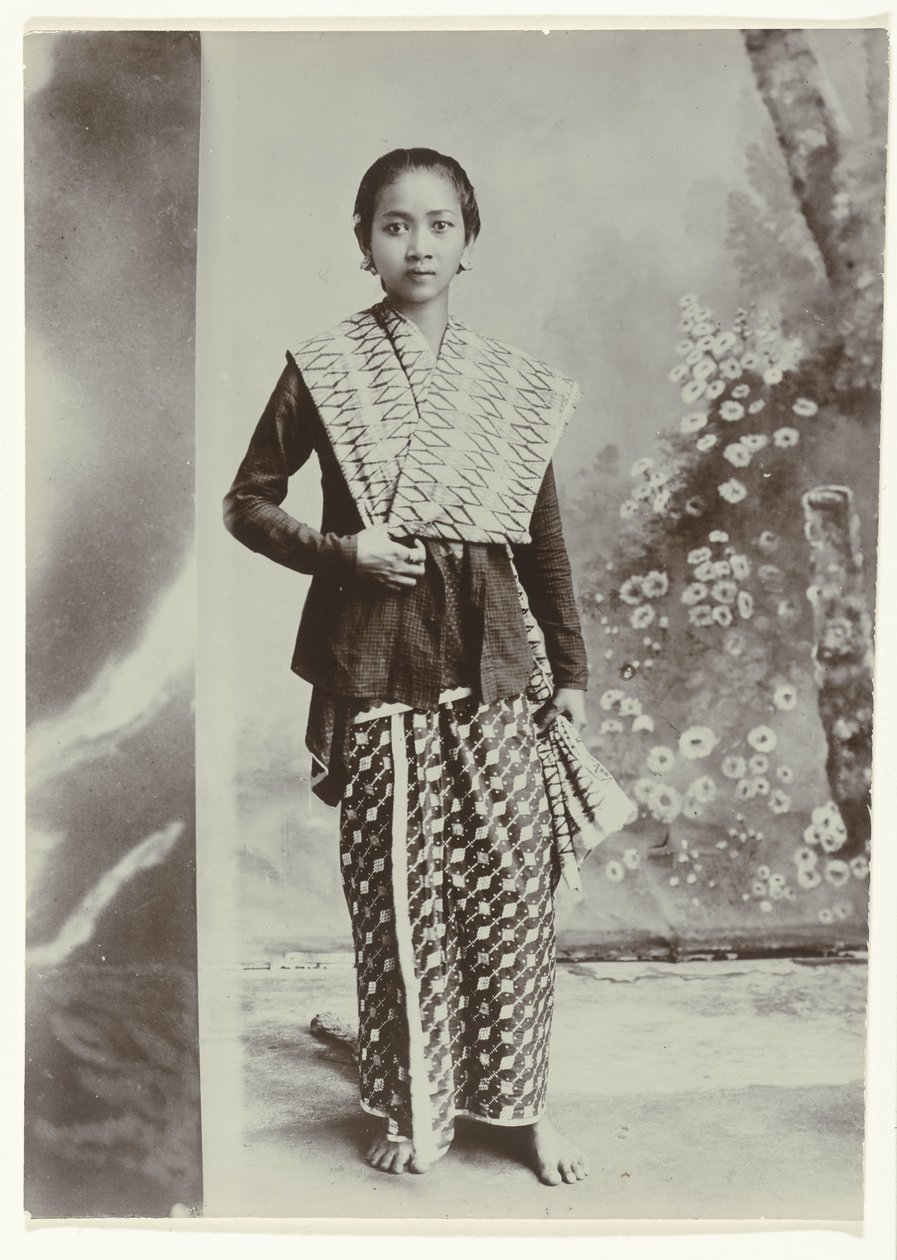 Studio portrait of a young Javanese woman in a sarong with batik motif ...