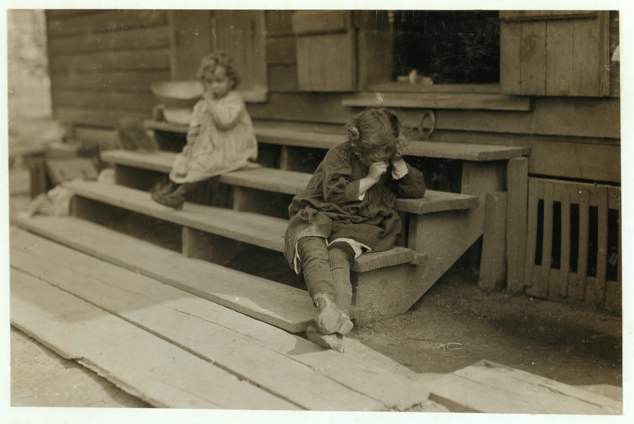 5 year old Olga Schubert began work about 5:00 A.M. helping her mother in the Biloxi Canning Factory, Mississippi, picking shrimps. She was tired out and refused to be photographed, 1911 by Lewis Wickes Hine