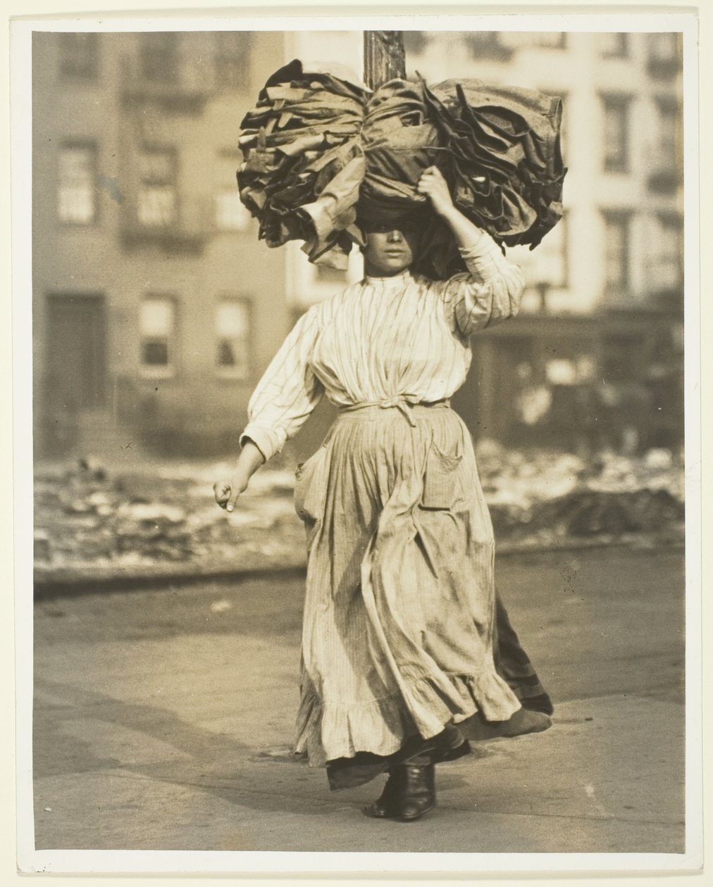 First Work in America, Italian Immigrant Carries Garments To The Tenement Home by Lewis Wickes Hine