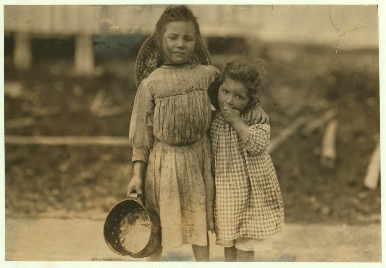 Maud and Grade Daly, 5 and 3 years old pick about a pot of shrimp each day for the Peerless Oyster Company, Bay St. Louis, Mississippi, 1911 by Lewis Wickes Hine