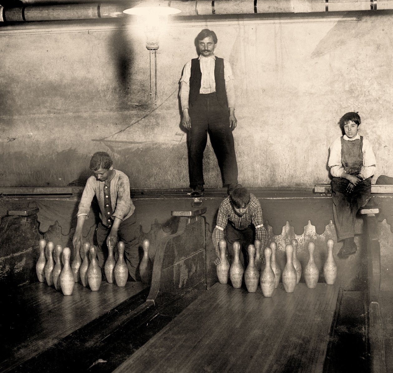 Pinboys in a Subway bowling alley, 65 South Street, Brooklyn. New York. 1910 by Lewis Wickes Hine