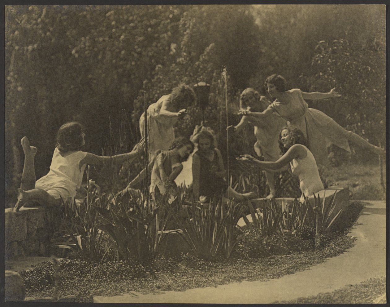 Dancers Posed Along Garden Wall by Louis Fleckenstein
