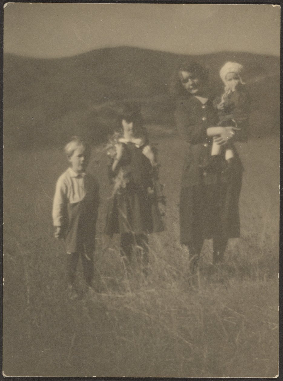 Woman and Three Children in Field by Louis Fleckenstein