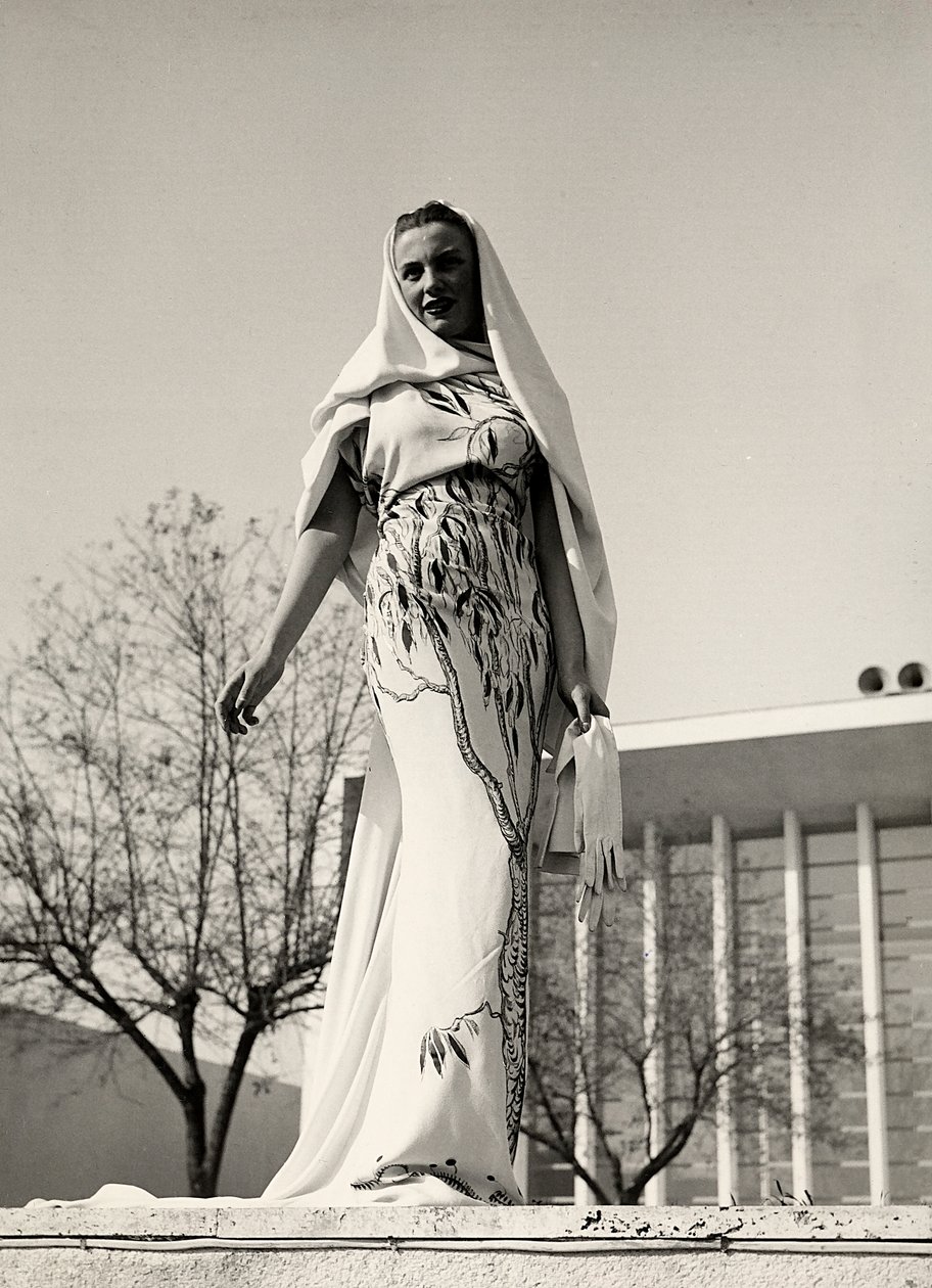 Model in an evening dress of floral print fabric, created by the couture house 