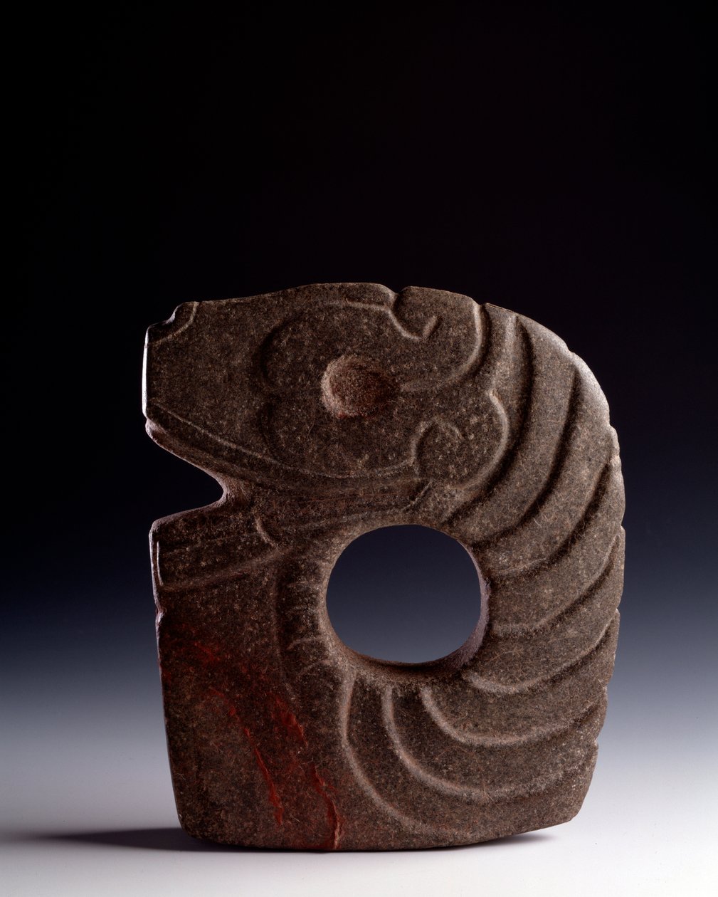 Zoomorphic axe in carved stone representing a stylized snake by Mayan Mayan