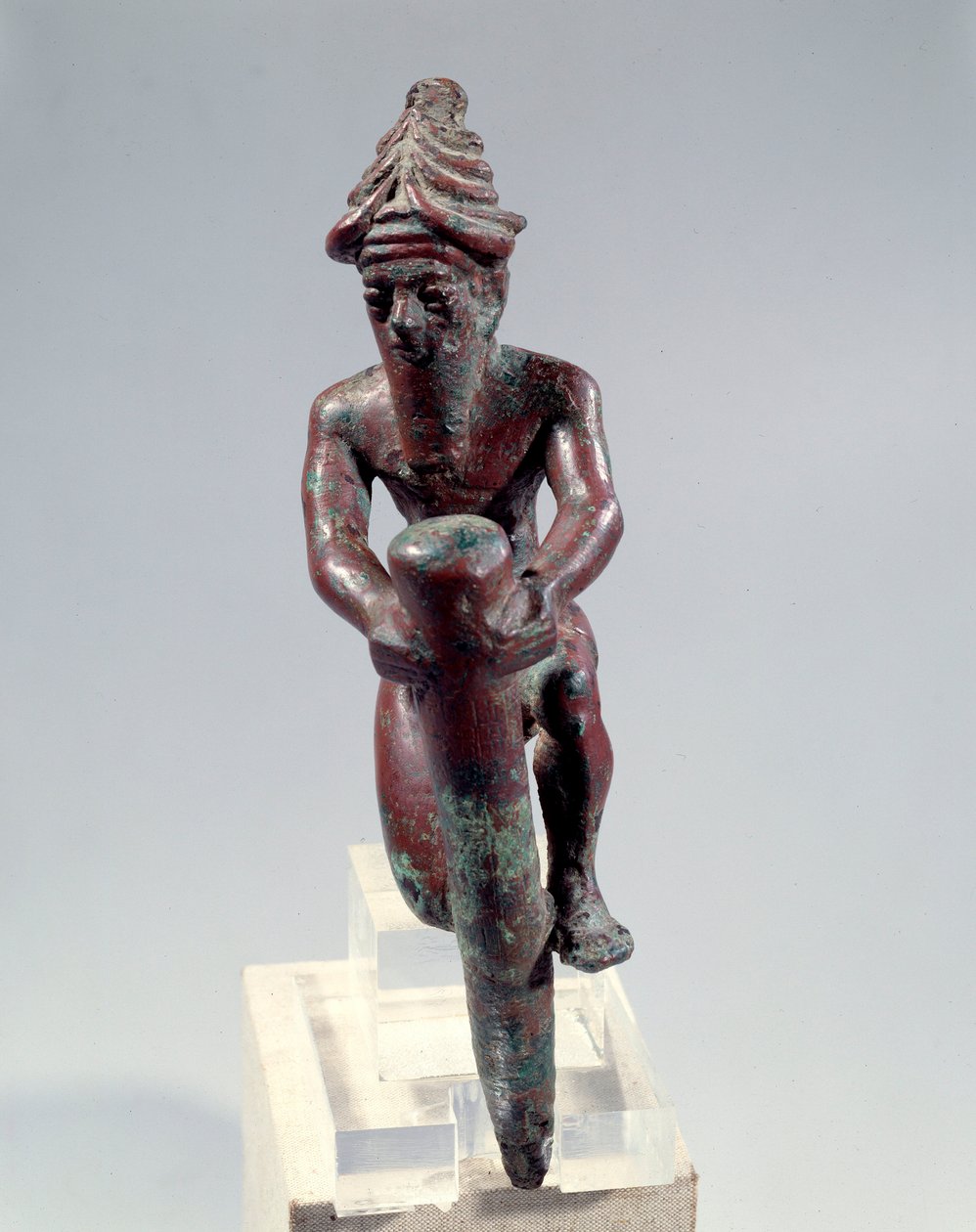Copper foundation figure depicting a god pushing a nail by Mesopotamian Mesopotamian