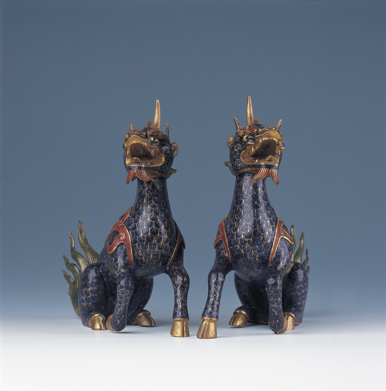 A pair of seated qilin by Ming Dynasty - Wanli Period Chinese School