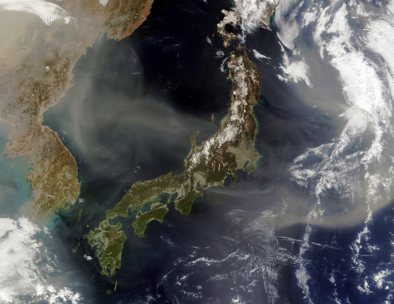 Satellite view of Japan with snow-covered mountains, Spring greening land at lower levels. Dust from mainland China blowing over the Sea of Japan, and out into the Pacific Ocean by National Aeronautics and Space Administration National Aeronautics and Space Administration
