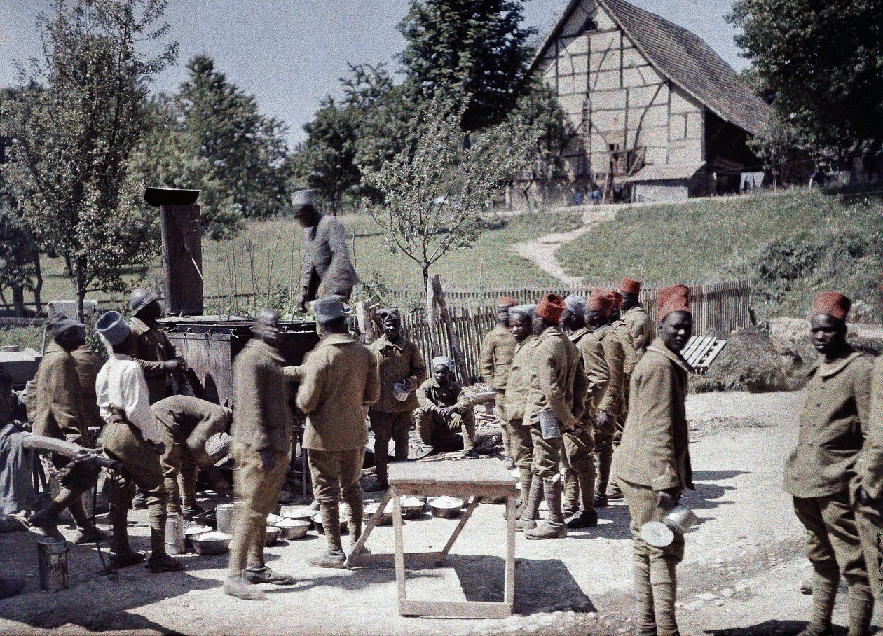 A group of Senegalese soldiers serving in the French Army as infantrymen having lunch in Saint-Ulrich, Department Haut-Rhin, Alsace, France, June 16, 1917 by Paul Castelnau