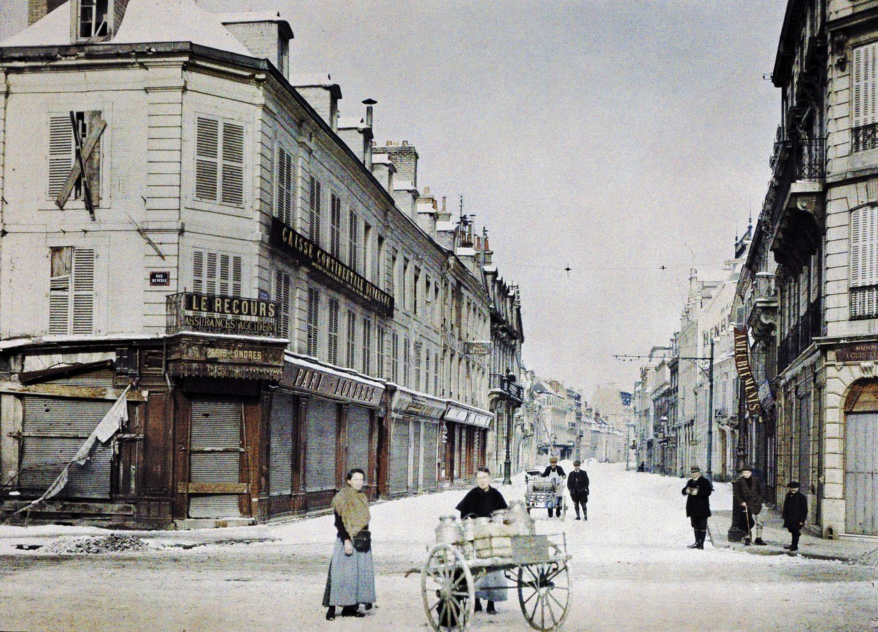 A woman with a cart filled with milk cans in Rue de Vesle and a man with another cart in Rue de Talleyrand behind her, Reims, France, March 3, 1917 by Paul Castelnau