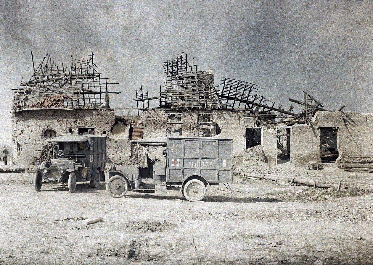 Two ambulance vehicles in front of a building devastated by artillery fire, Belgium, September 17, 1917 by Paul Castelnau