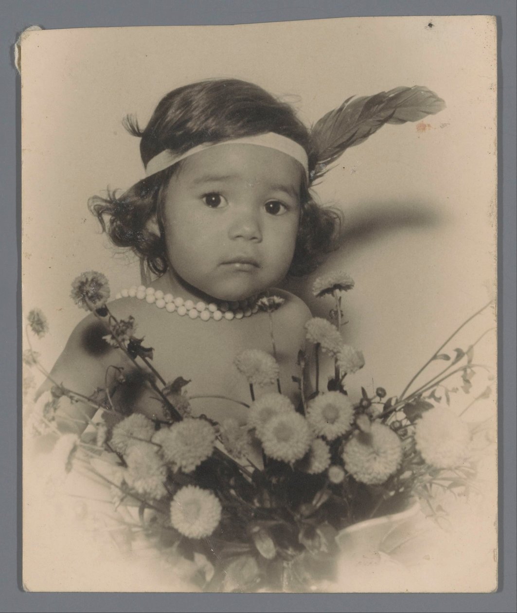 Portrait of an Unknown Child with a Headband and a Bouquet of Flowers by Paul Rollman