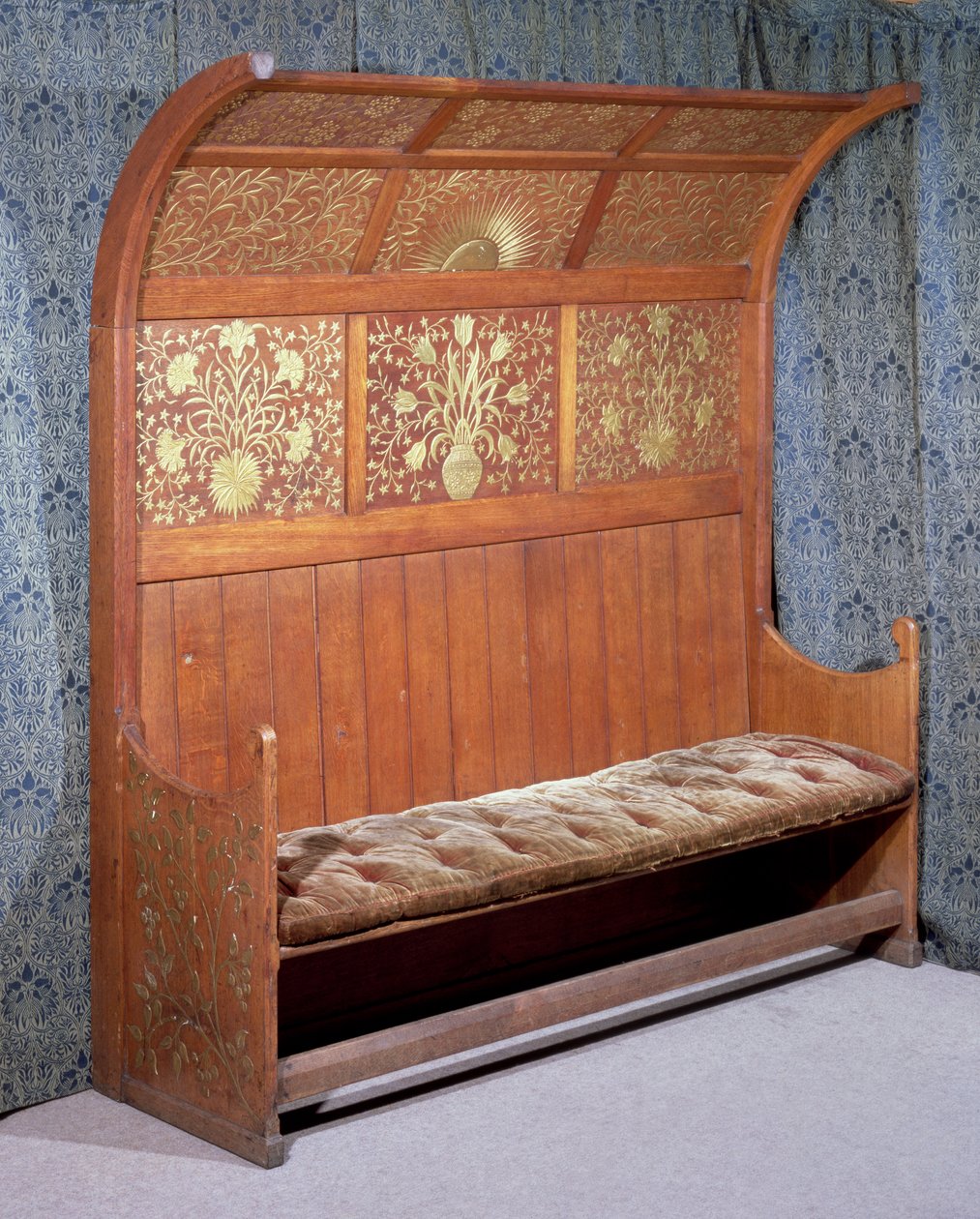 Settle with gilded gesso decoration, made by Morris and Company by Philip Webb