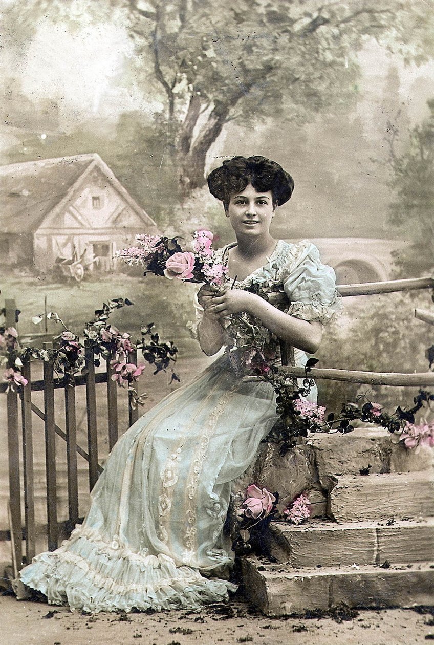 Woman with garland of flowers, postcard, c. 1900 by Photographer French