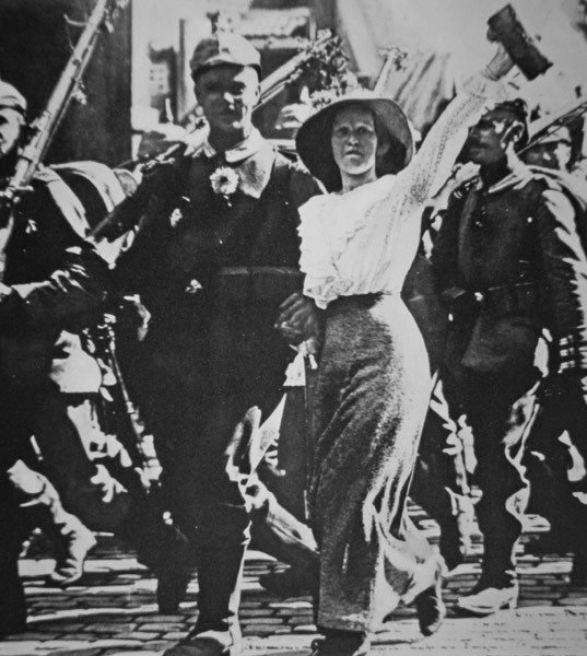 WWI German Troops Marching Off to War, Their Tunics & Rifles Festooned with Flowers from the Jubilant Crowd by Photographer German
