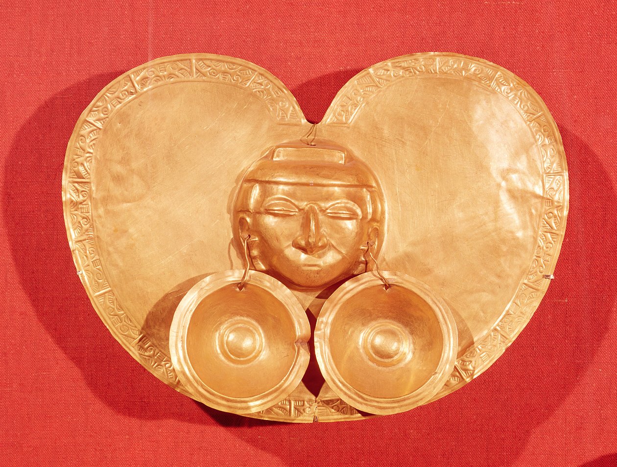 Pectoral with a human face wearing earrings, from Restrepo, Cauca Valley, Calima Period by Pre Columbian
