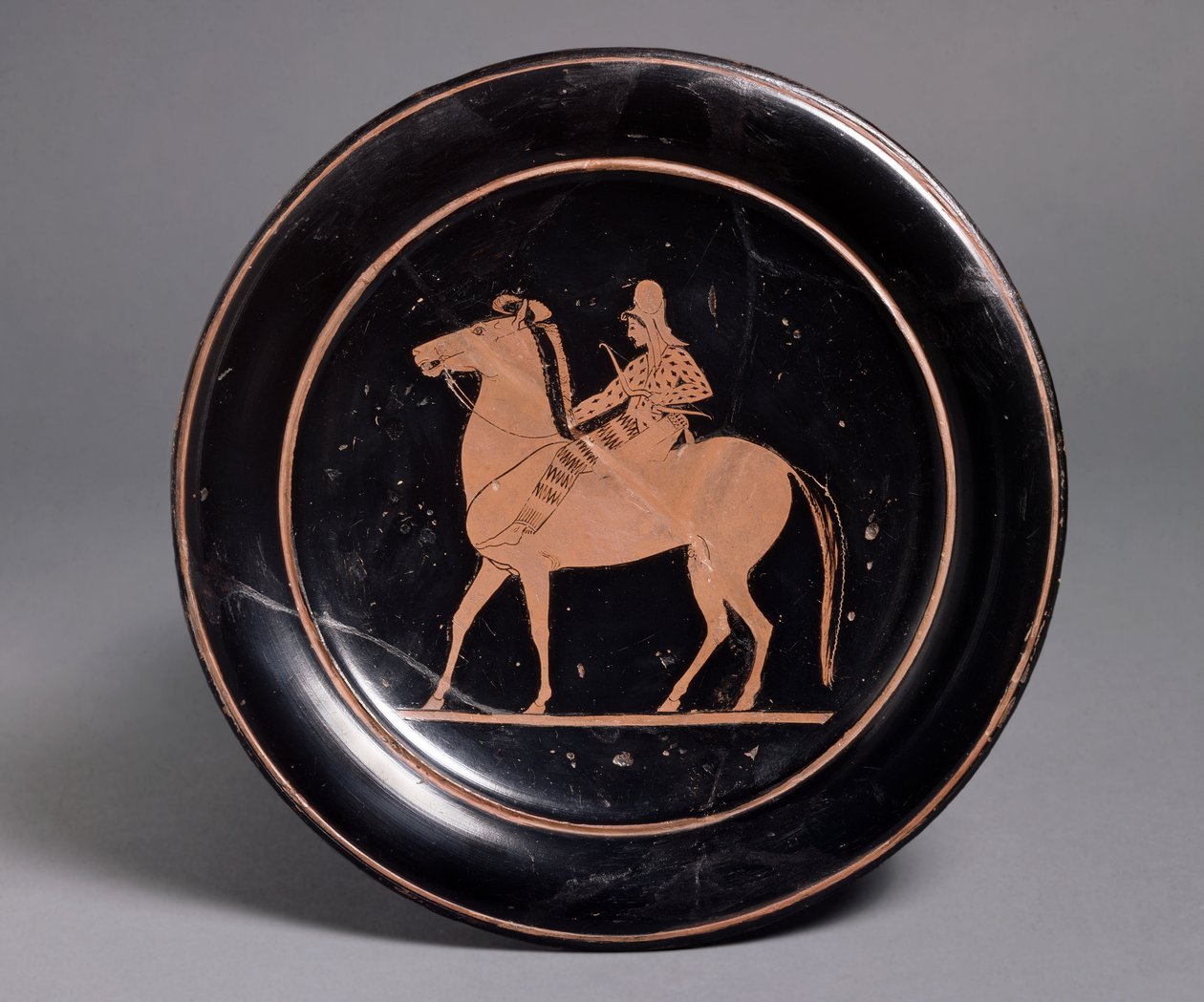 Attic red-figure plate showing a mounted archer in oriental costume, inscribed Miltiades kalos, 520-510 BC by Roman