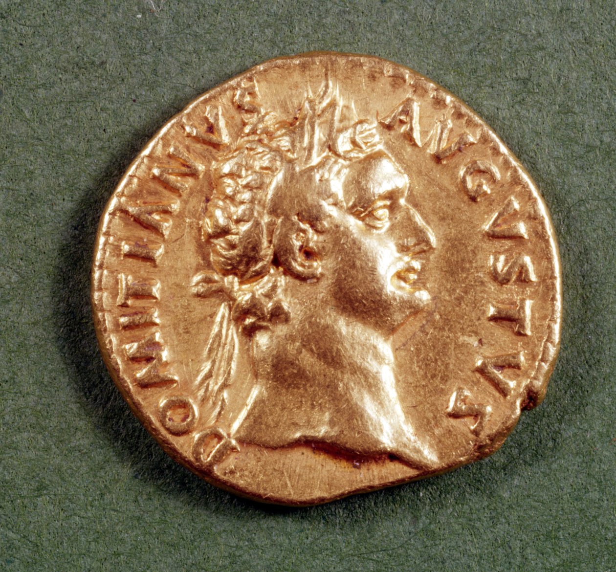 Aureus (obverse) of Domitian (AD 81-96) wearing a laurel wreath. Inscription: DOMITIANVS AVGVSTVS by Roman