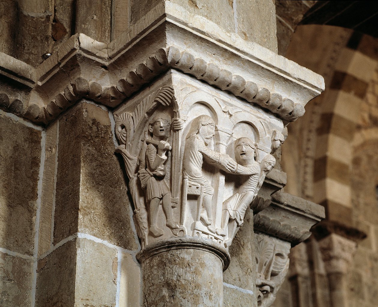 Esau returns from hunting and finds himself in front of his father Isaac who is blessing Jacob (carved capital) by Romanesque