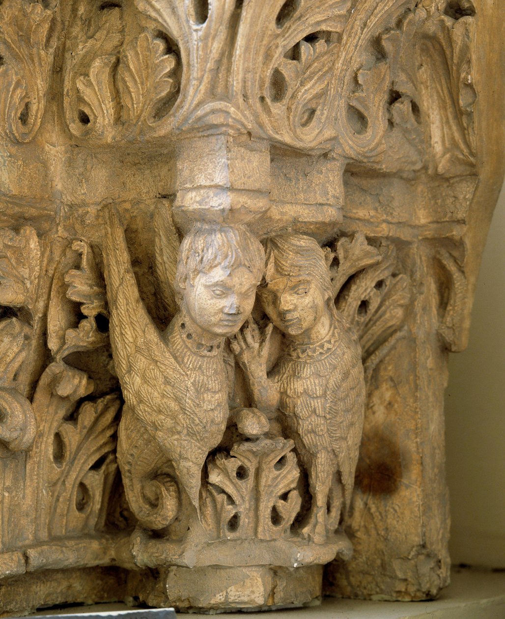 Top decorates sirens and birds on the model of those of the Church Saint Loup de Naud by Romanesque