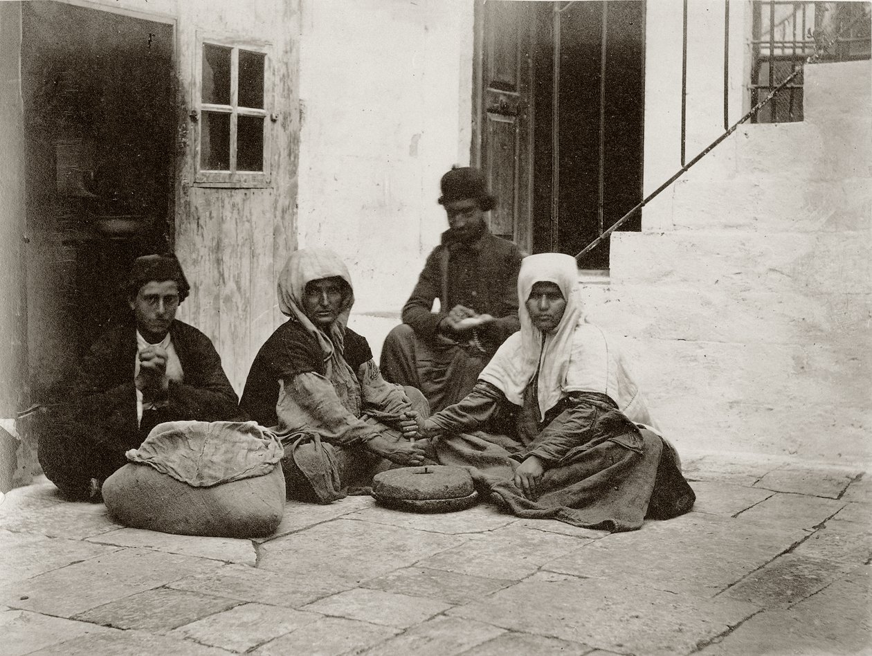 Women grinding flour with round millstones within a courtyard of a house in Jerusalem by Sergeant Henry Phillips