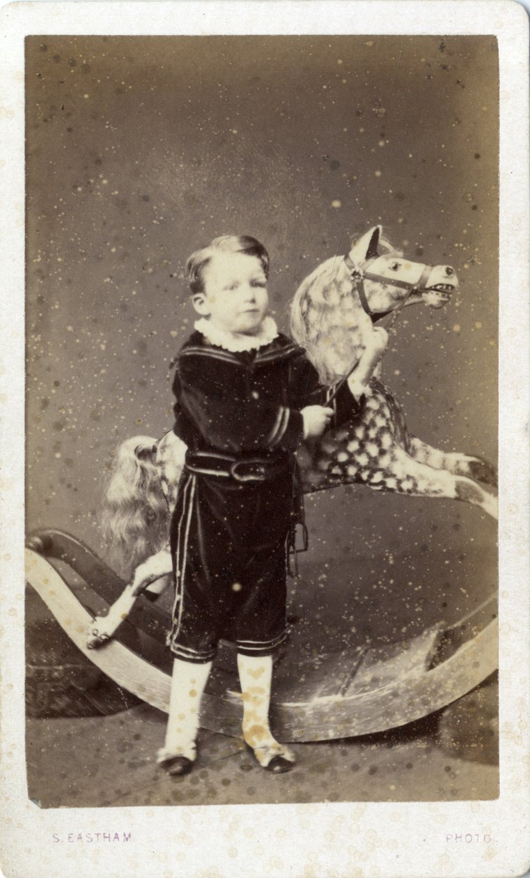 Young Boy Standing by a Rocking Horse by Silas Eastham