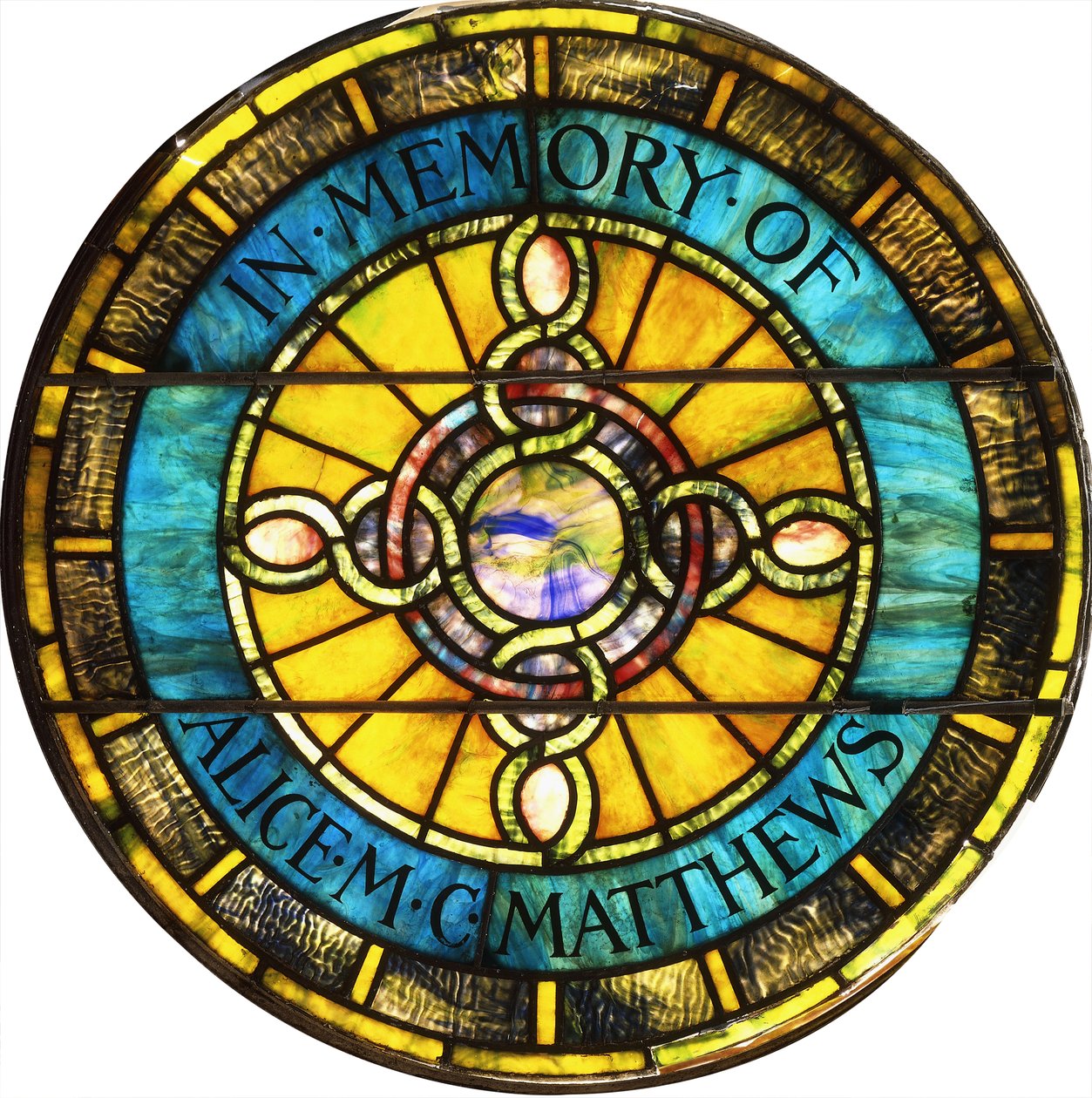 A circular leaded glass window by Tiffany Studios by Studios Tiffany