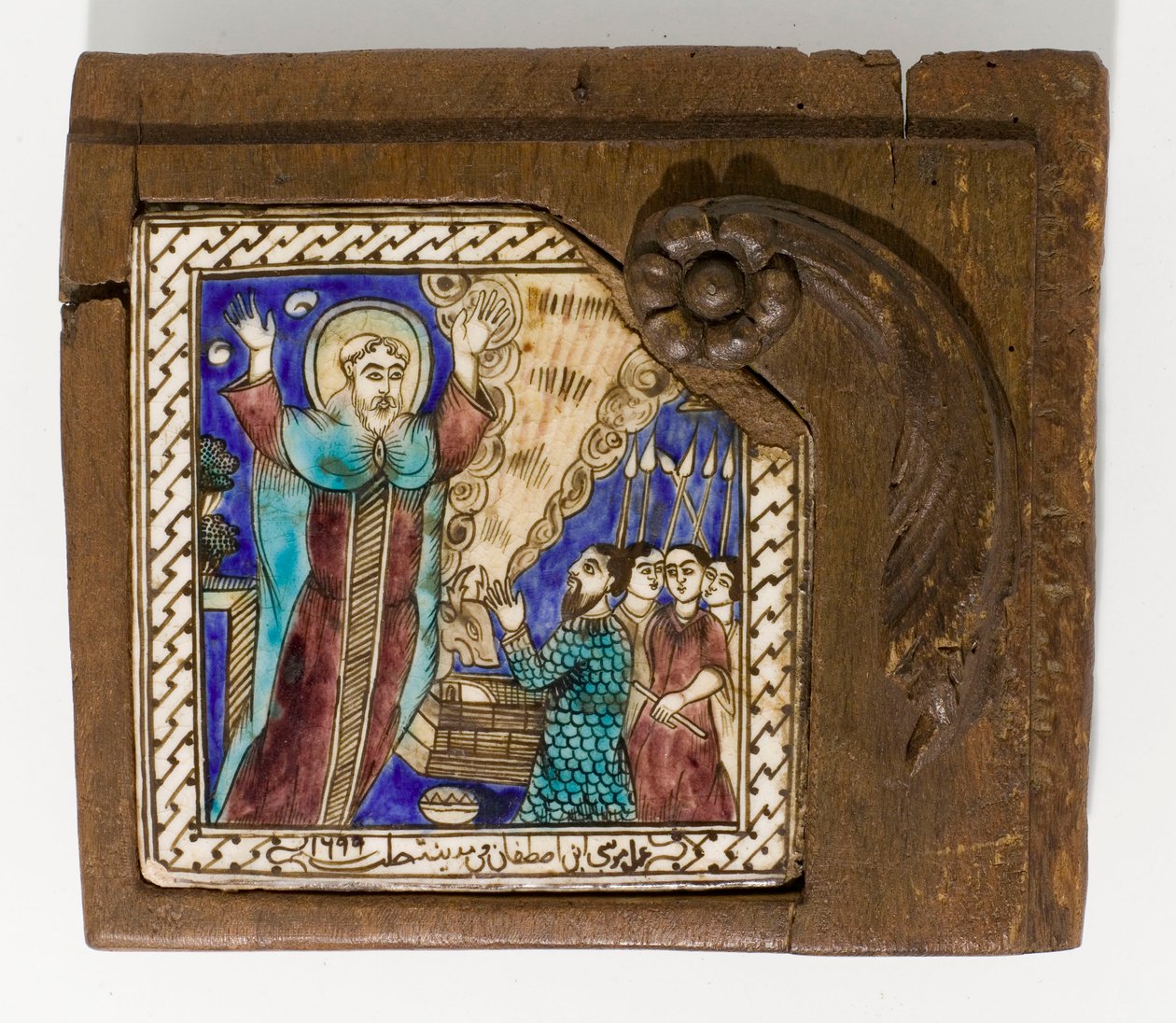 A signed and dated Syrian ceramic tile, painted in manganese, blue and brown, dated 1699 by Syrian School