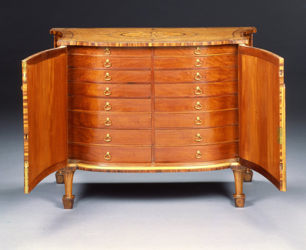 One of a pair of George III commodes by Thomas Chippendale