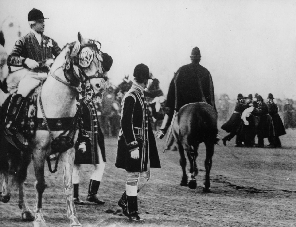 A suffragette attempts to attack the king as he arrives to open parliament, 1908 by Thomas E. and Horace Grant Grant