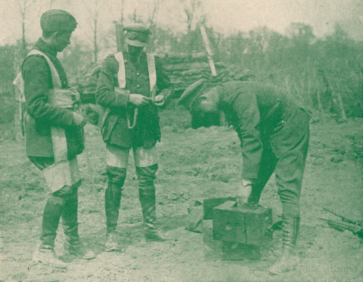 Aerial photographers fixing on parachute harnesses before making an ascent, c1917 by Unbekannt