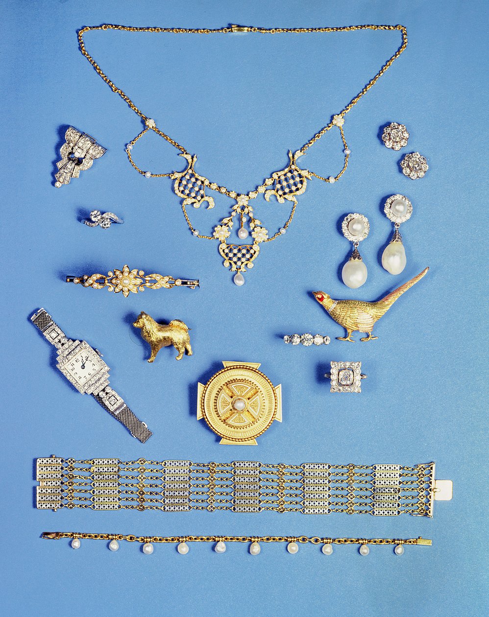 Selection of jewellery: pearl and gold pendant; Art Deco diamond clip brooch; pearl drop earrings; Celtic style gold brooch; Edwardian chain bracelet; pheasant brooch; half pearl gold hinged bangle by Unbekannt Unbekannt
