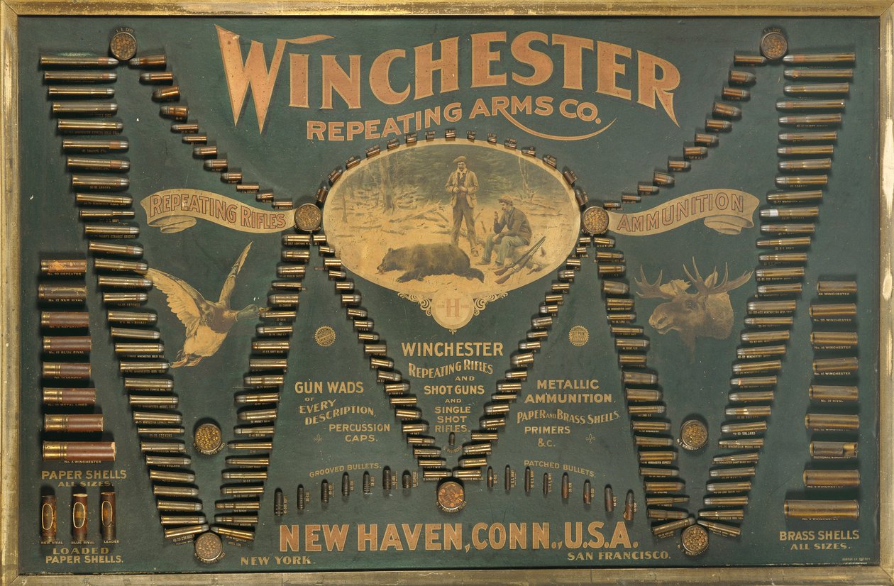 A Winchester Cartridge display board, with a comprehensive selection of metallic, brass and paper-case rifle and shot cartridges arranged in the form of an extended 