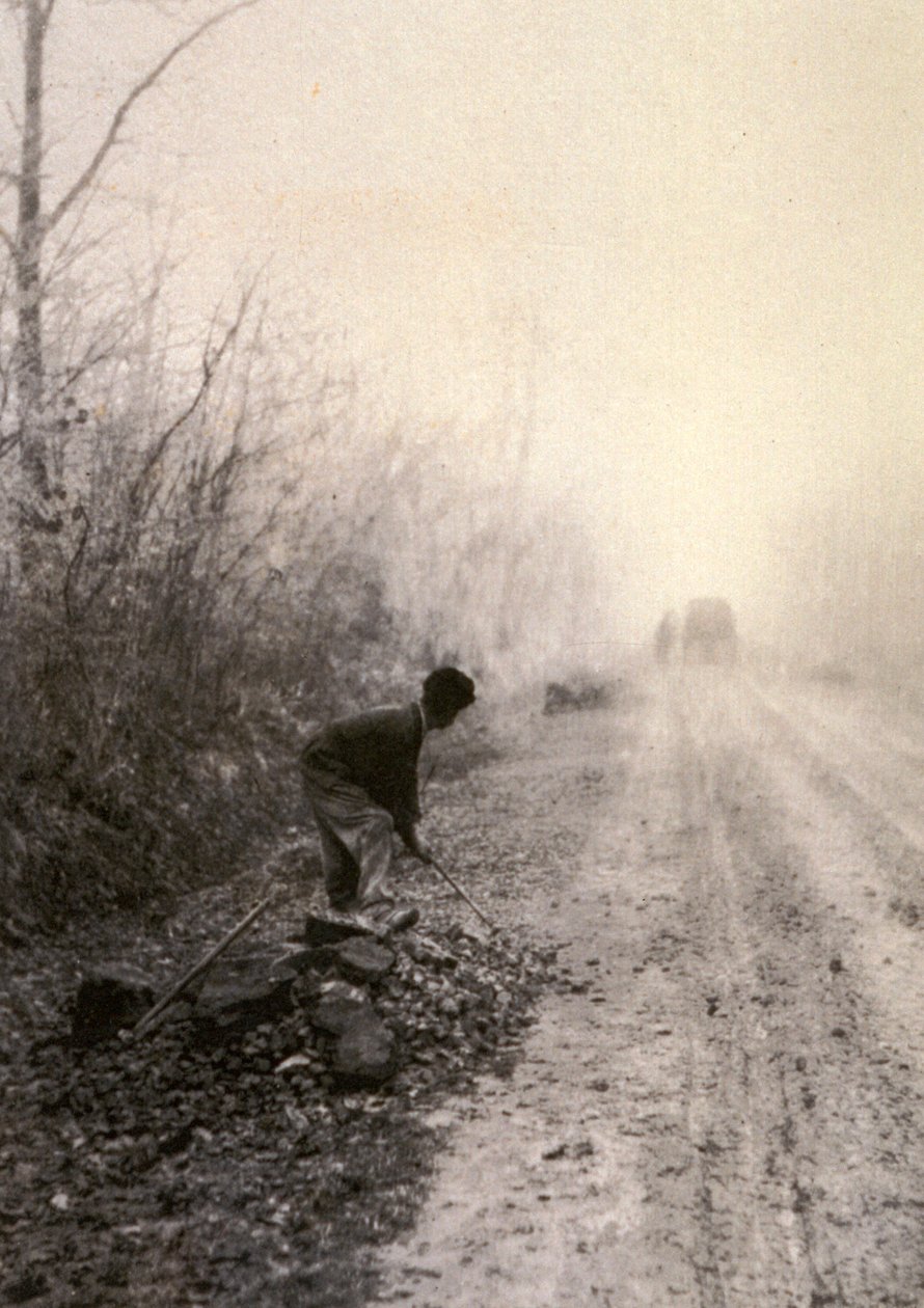 A Country Road Wrapped in Morning Mists with a Man Splitting Stones in the Foreground by Unbekannter Künstler