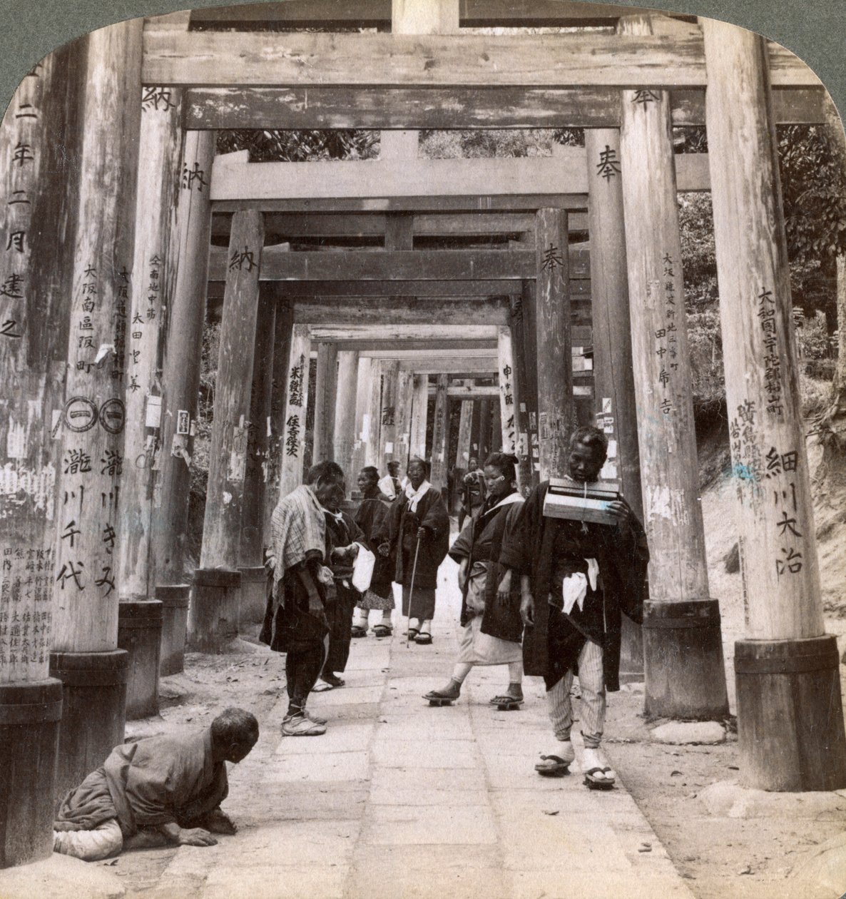 Coming and Going Under Long Rows of Sacred Torii, Shinto Temple of Inari, Kyoto, Japan by Underwood and Underwood