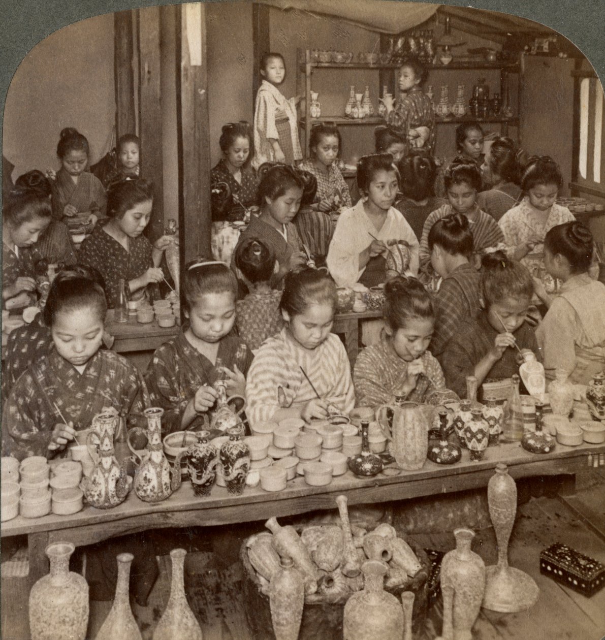 Factory girls decorating cheap pottery for the foreign markets, Kyoto, Japan, 1904 by Underwood and Underwood