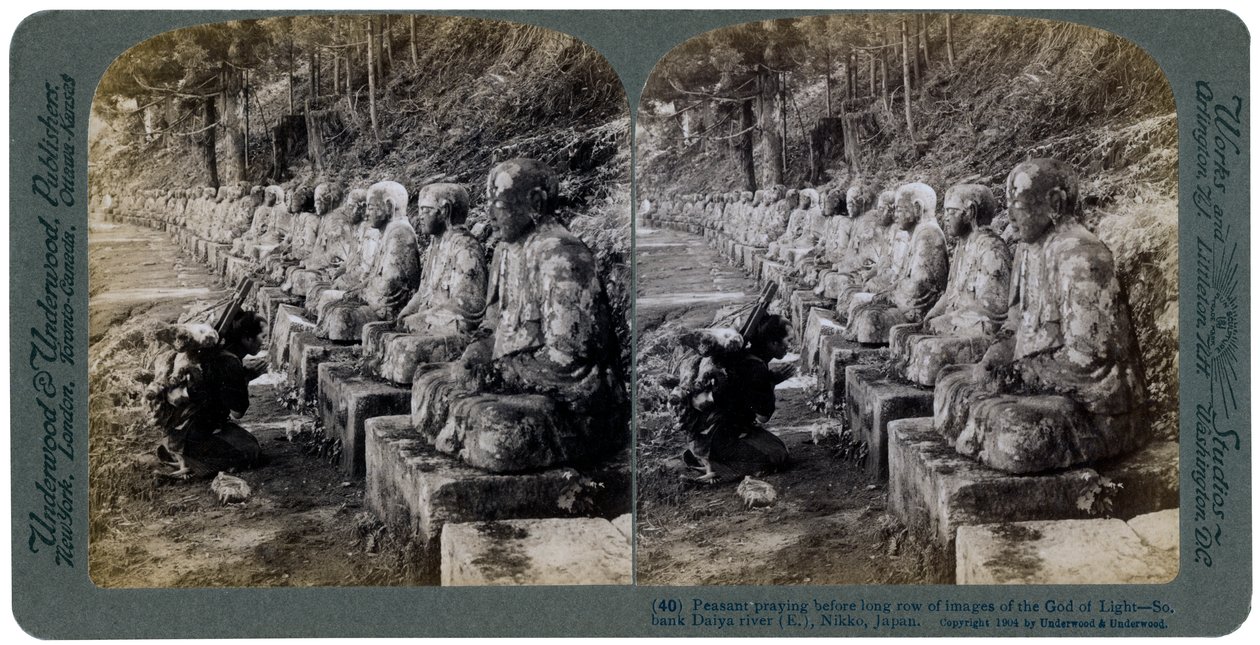 Peasant Praying Before a Row of Statues of the God of Light, Daiya River, Nikko, Japan, 1904 by Underwood and Underwood
