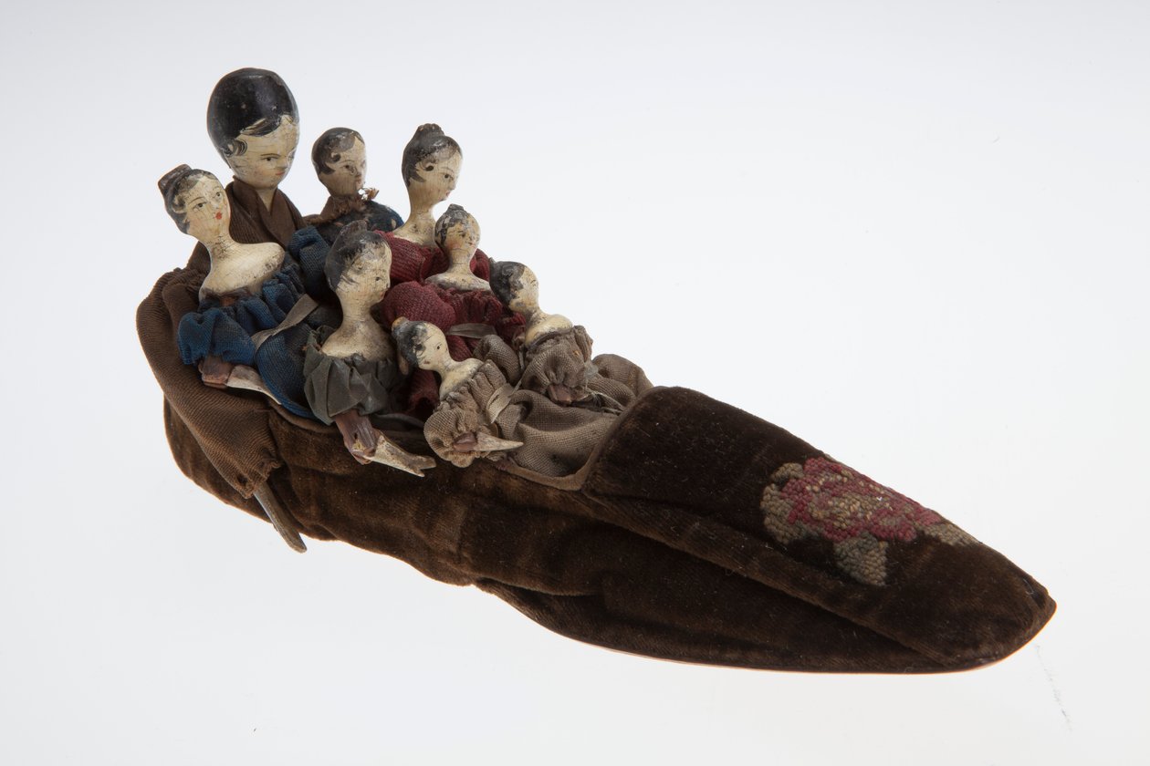 Old Woman who Lived in a Shoe Toy. The Toy Features a Velvet Slipper with Eight Dolls Inside by Unknown