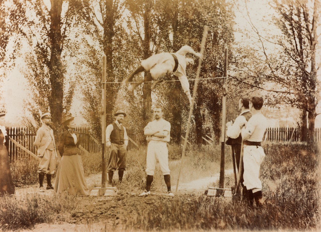 Portrait of a man who trains in the pole vaulting in front of some spectators by Unknown photographer