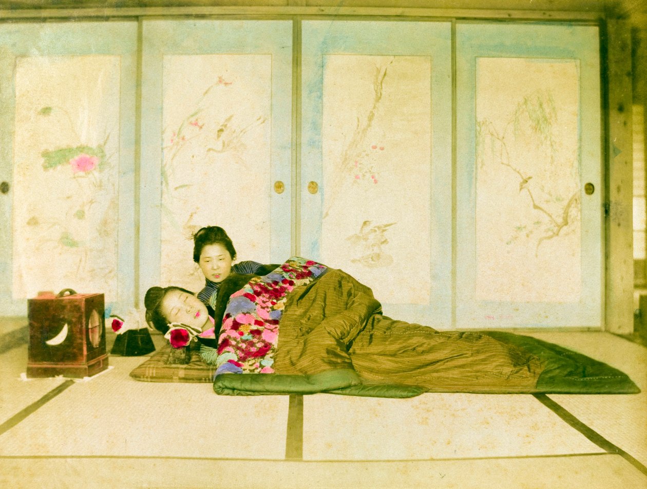 Reclining on a Futon. Two Japanese Women Recline on a Traditional Futon Placed on the Floor. Japan, circa 1910. by Unknown photographer