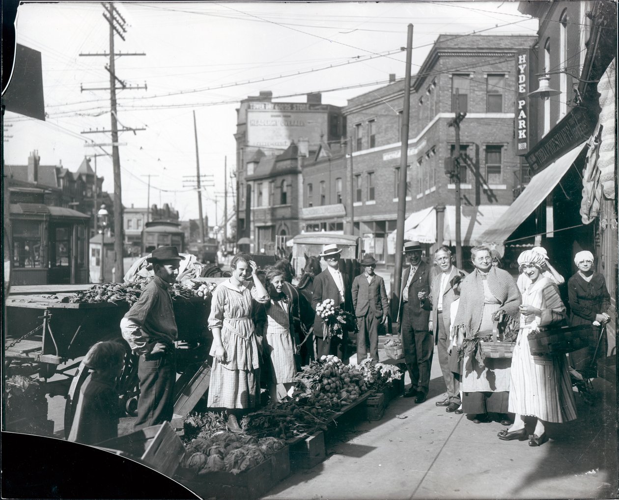 Shoppers Gathered by Sidewalk Produce Outside the Theodore Prieshoff Grocery, 1929 East Grand Avenue, Near the Grand Avenue Water Tower by William G. Swekosky