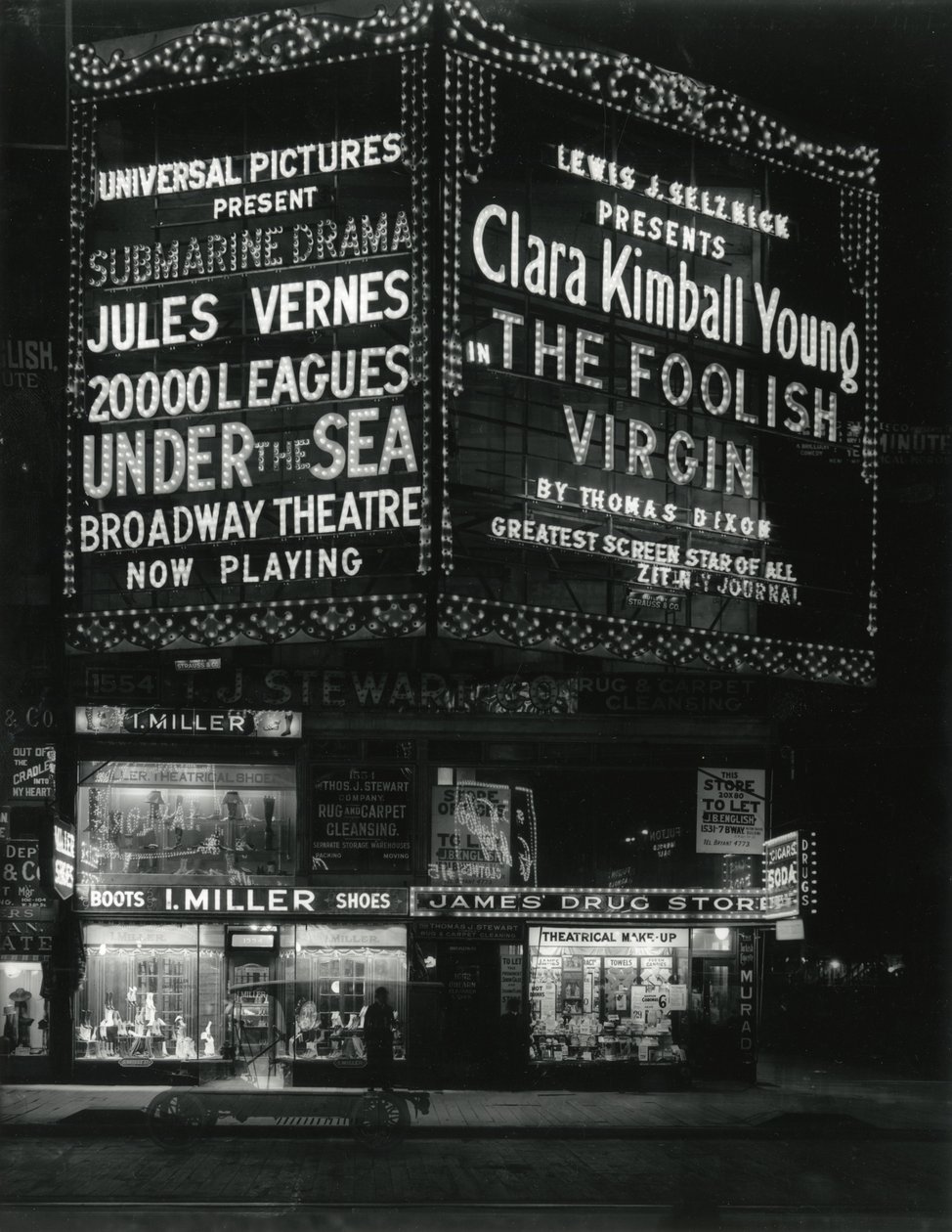 1554 Broadway at 46th Street, I. Miller Shoes; James Drug Store, and Large Marquees for Movies Lit Up Above by William Davis Hassler