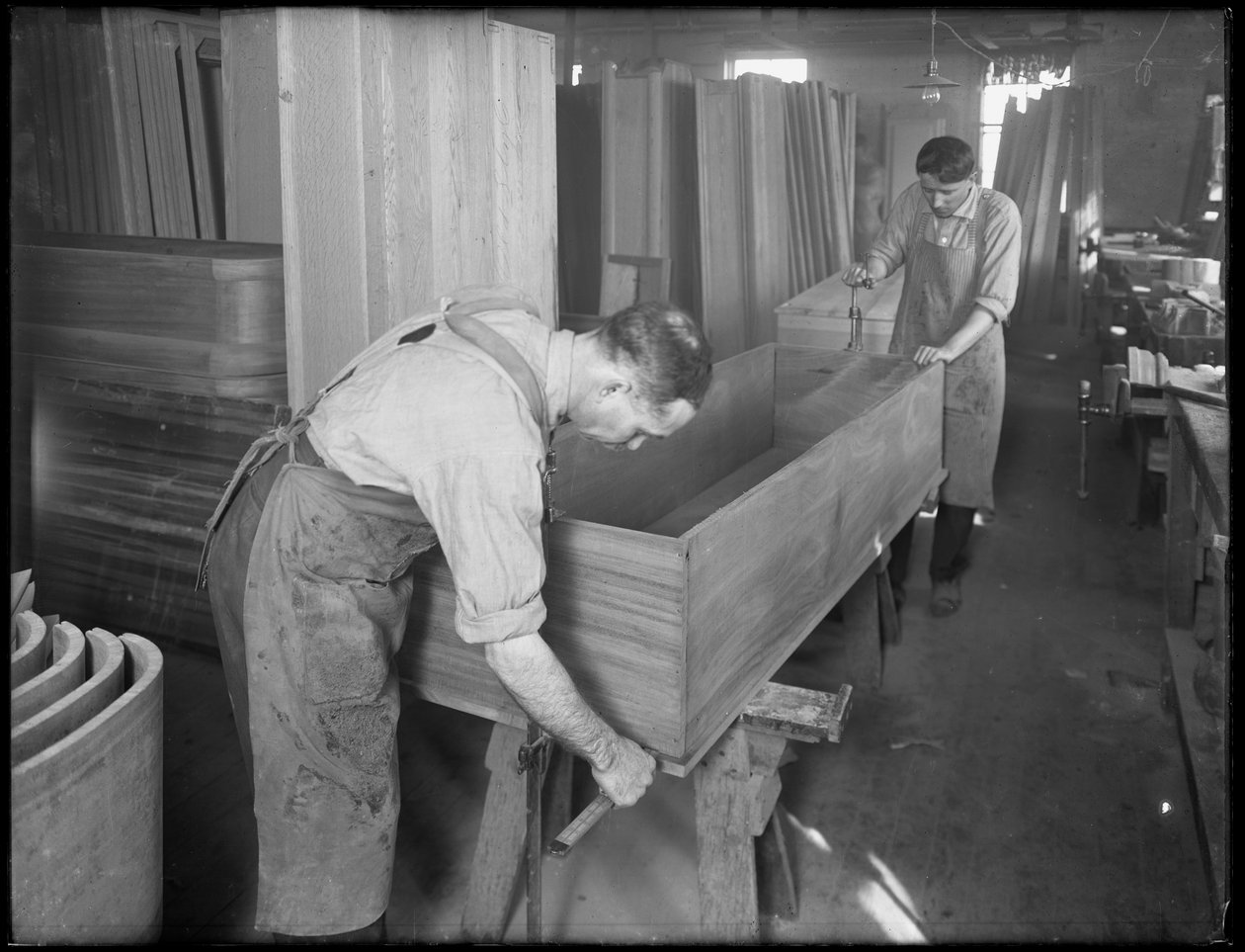 Adjusting the sides and bottom of the shell of a wooden casket, Oneida, New York, April 3, 1916 by William Davis Hassler