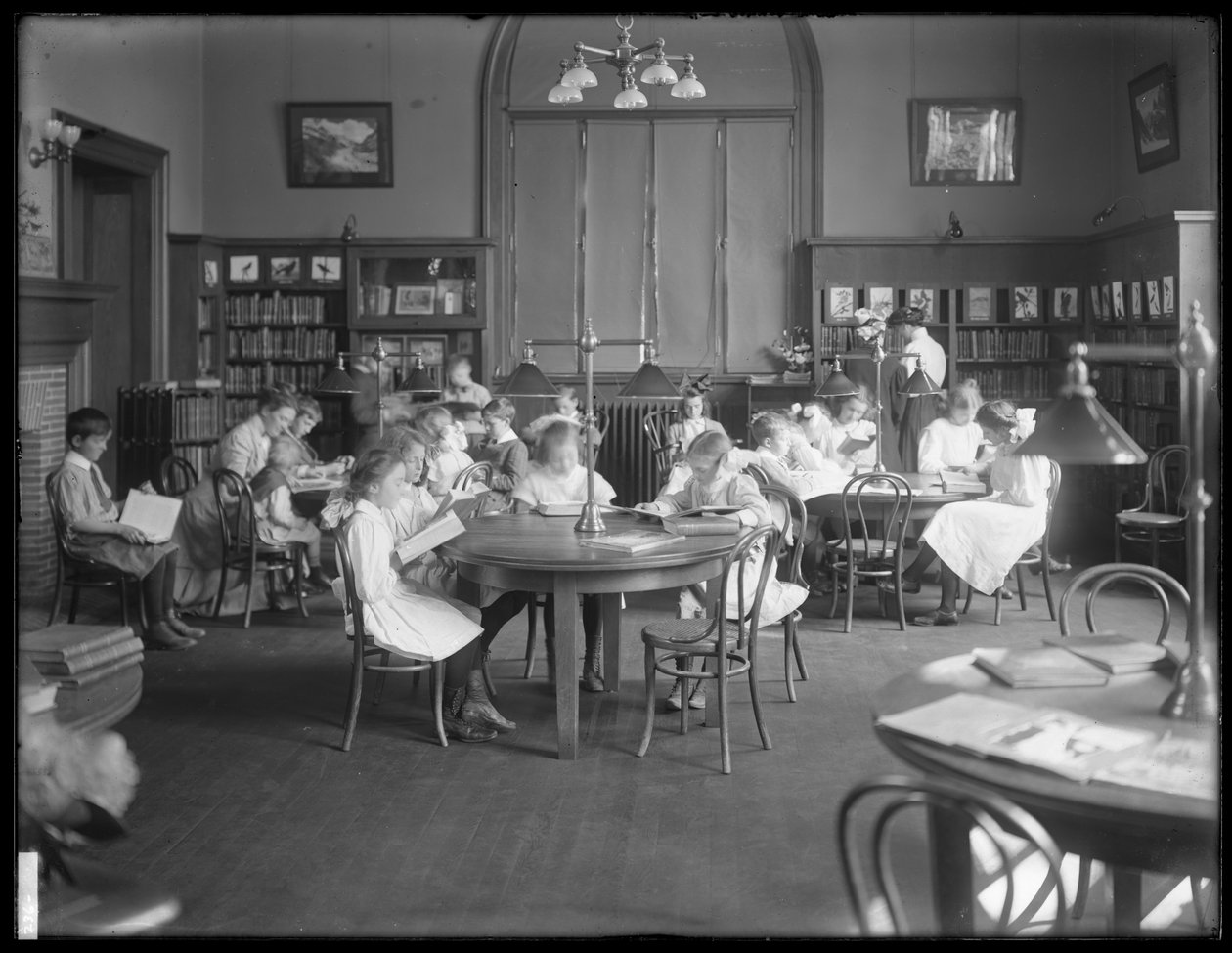 Children reading in the reading room of an unidentified branch of the Queens Borough Public Library, c.1910 by William Davis Hassler