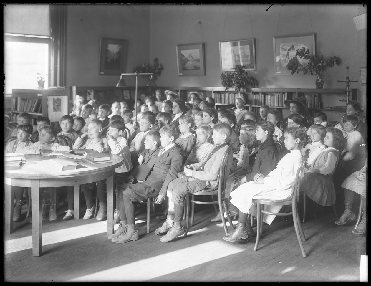 Children Seated, Listening in the Reading Room of an Unidentified Branch of the Queens Borough Public Library, c.1910 by William Davis Hassler
