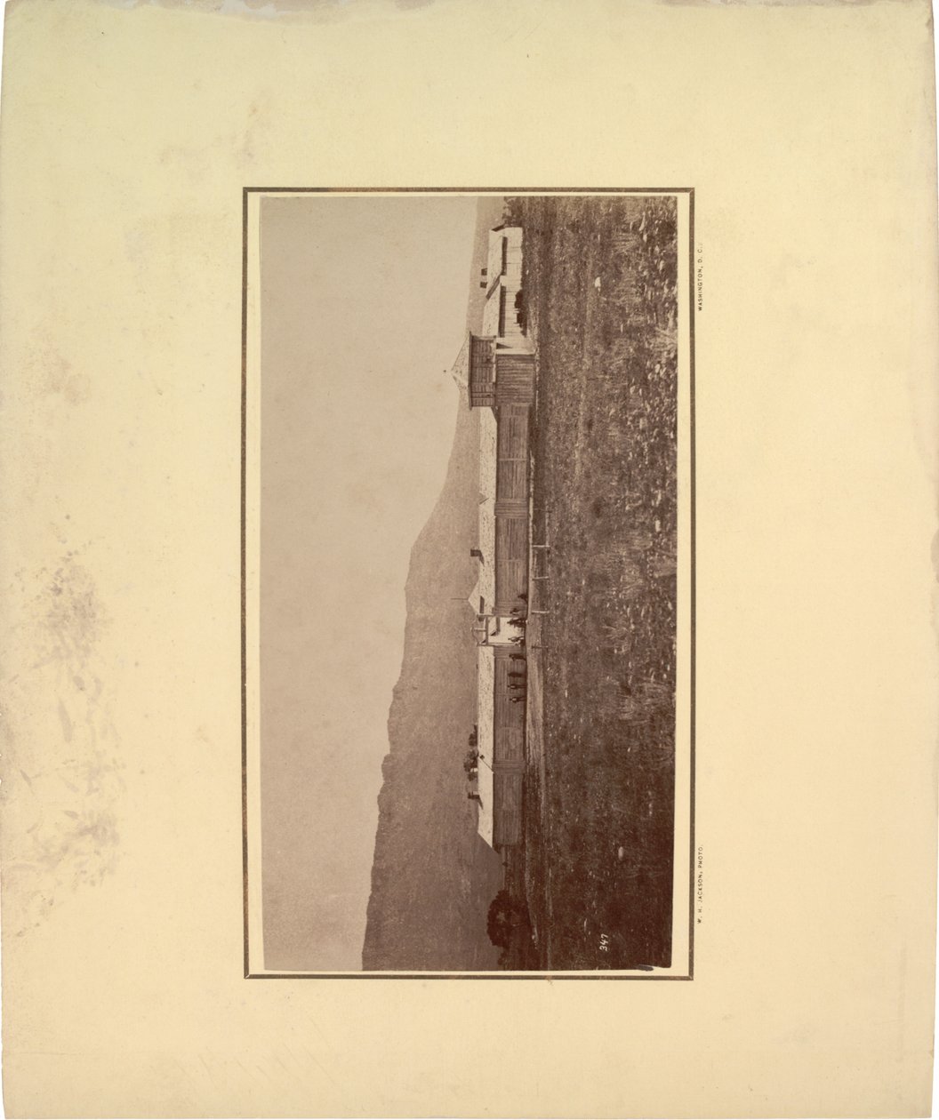 View of a stockade with several men gathered at entrance gate, 1871 by William Hicks Jackson